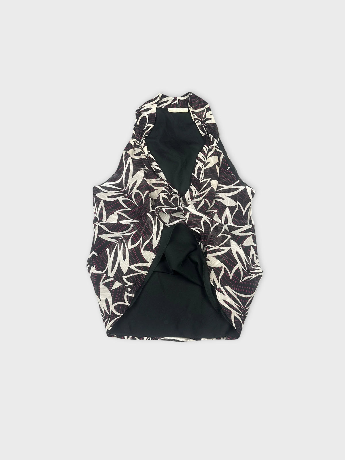 Detail view of a sleeveless top featuring a black and white leaf pattern.