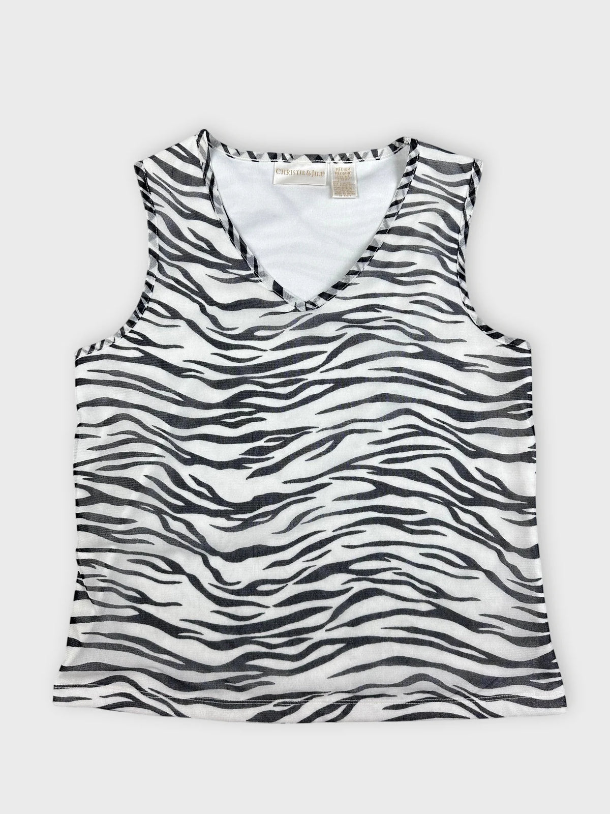 Detail view of a women’s sleeveless top in black and white zebra print.