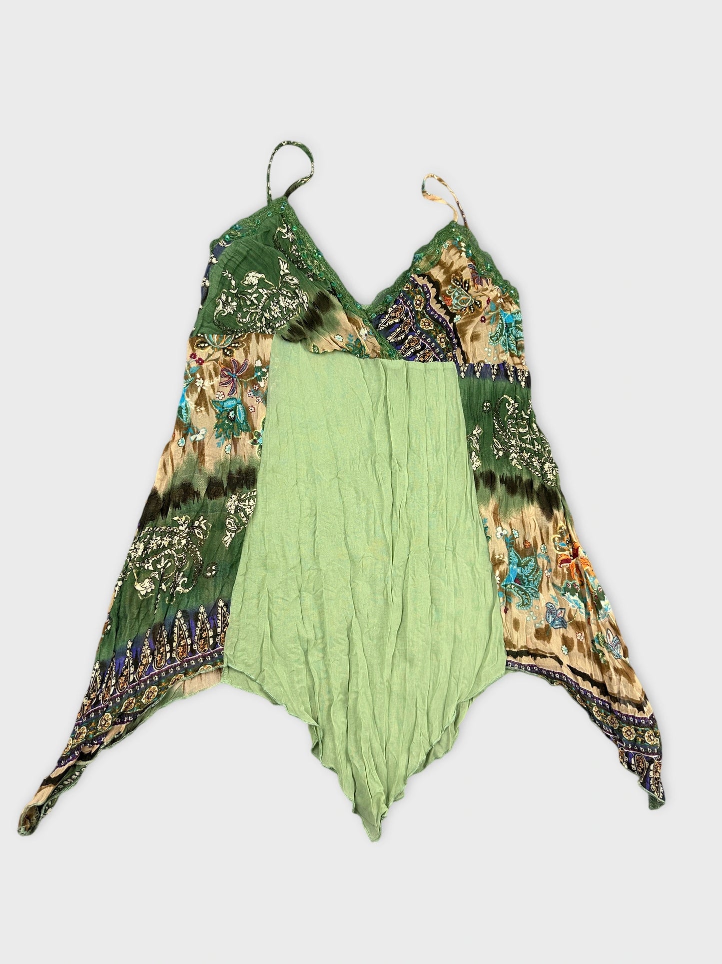 Detail view of a vintage green upper body top with patterned trim.