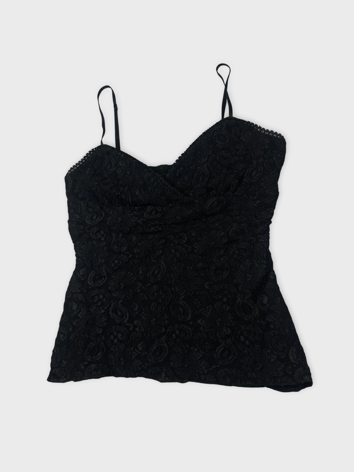Detail view of a black lace camisole top with thin straps.