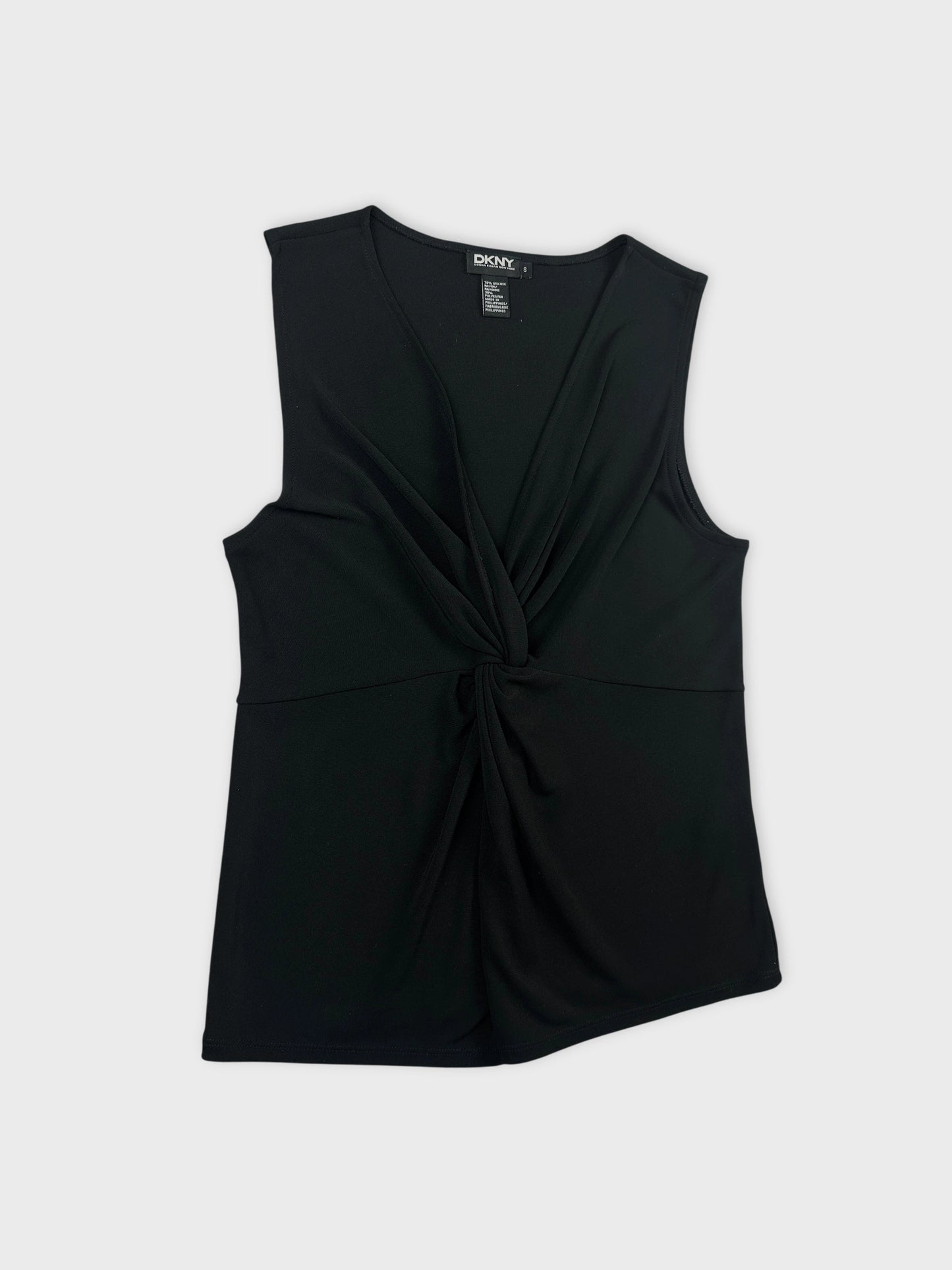 Detail view of a black sleeveless top featuring a knotted design.