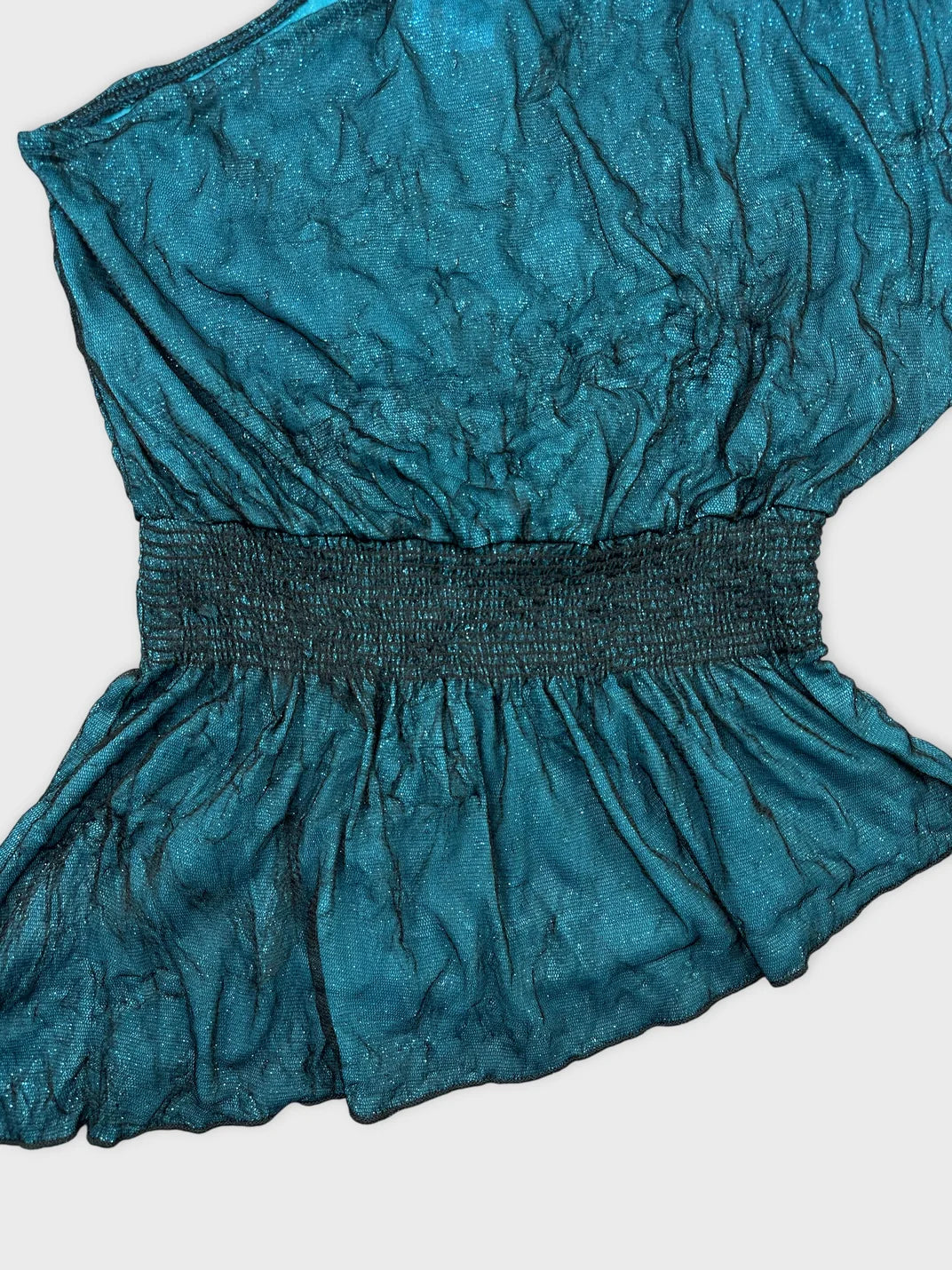Detail view of a teal vintage top with gathered trim.