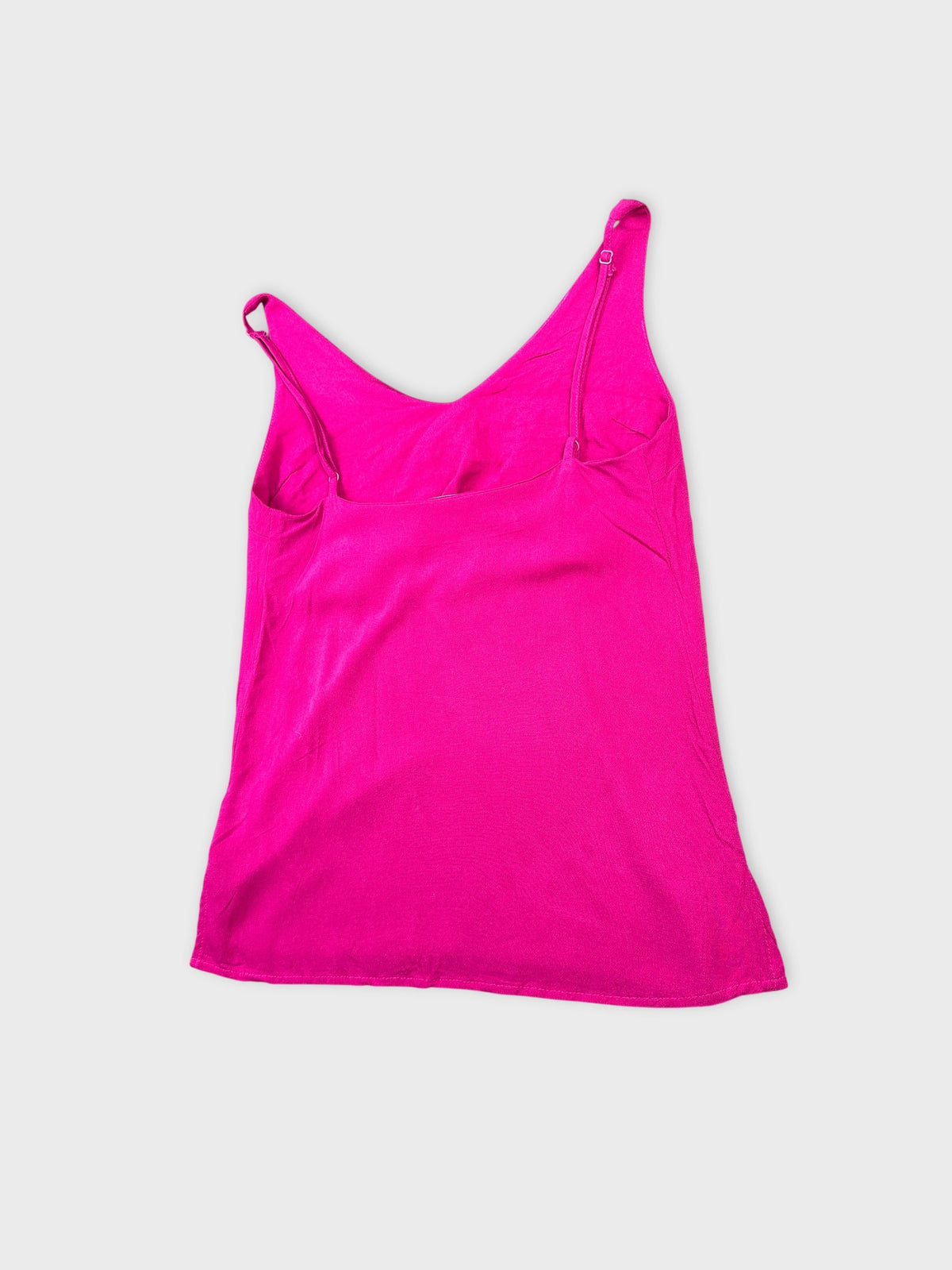 Detail view of a pink women's top with thin straps.