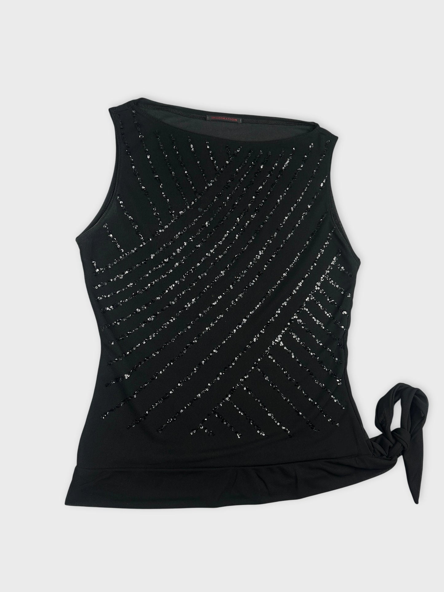 Detail view of a black sleeveless top with diagonal sequin pattern.