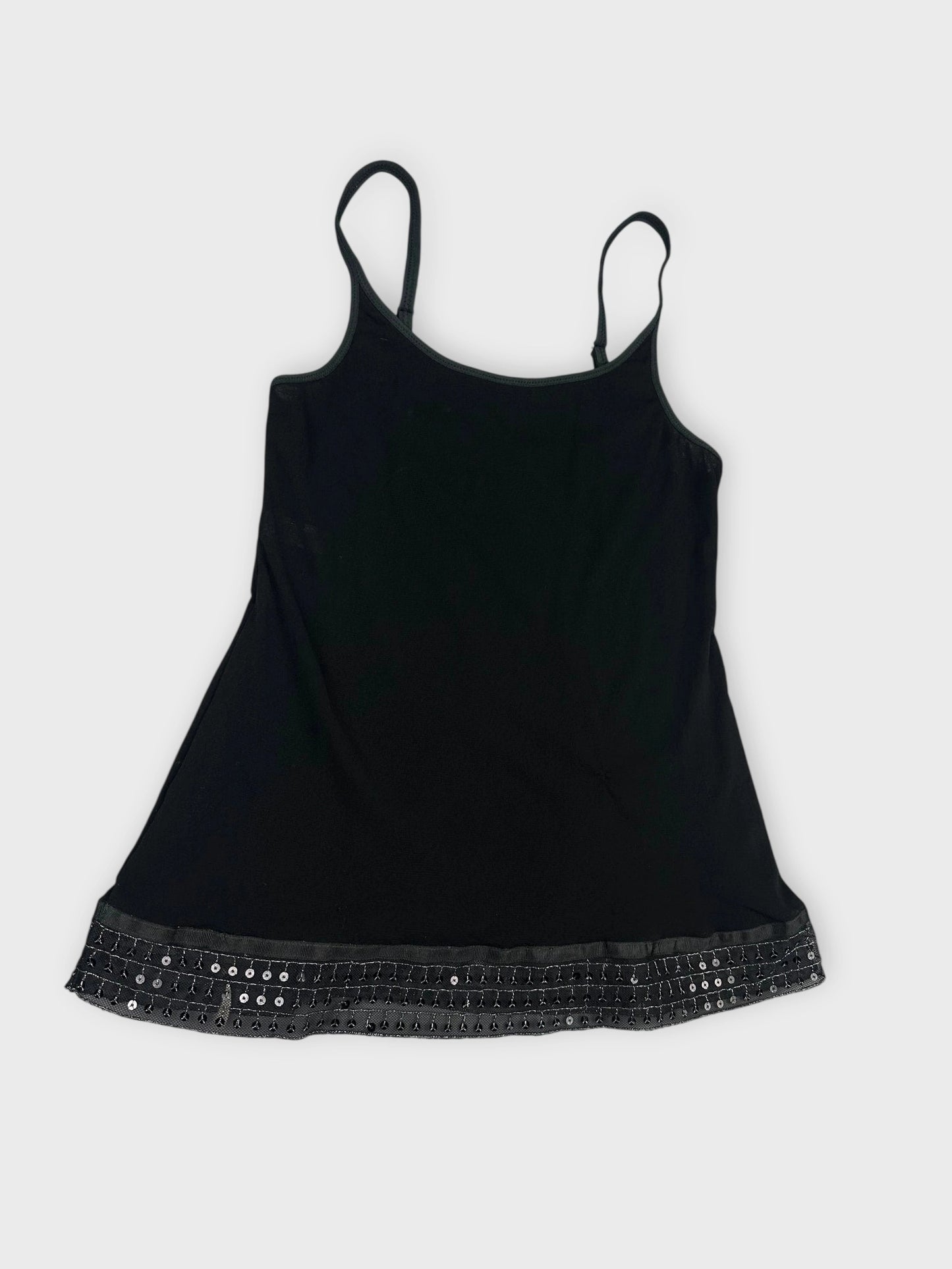 Detail view of a black women's top with a sequined trim.