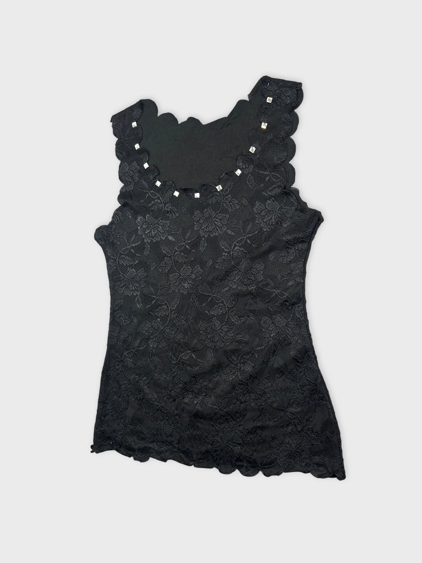 Detail view of a black lace tank top with scalloped edges.