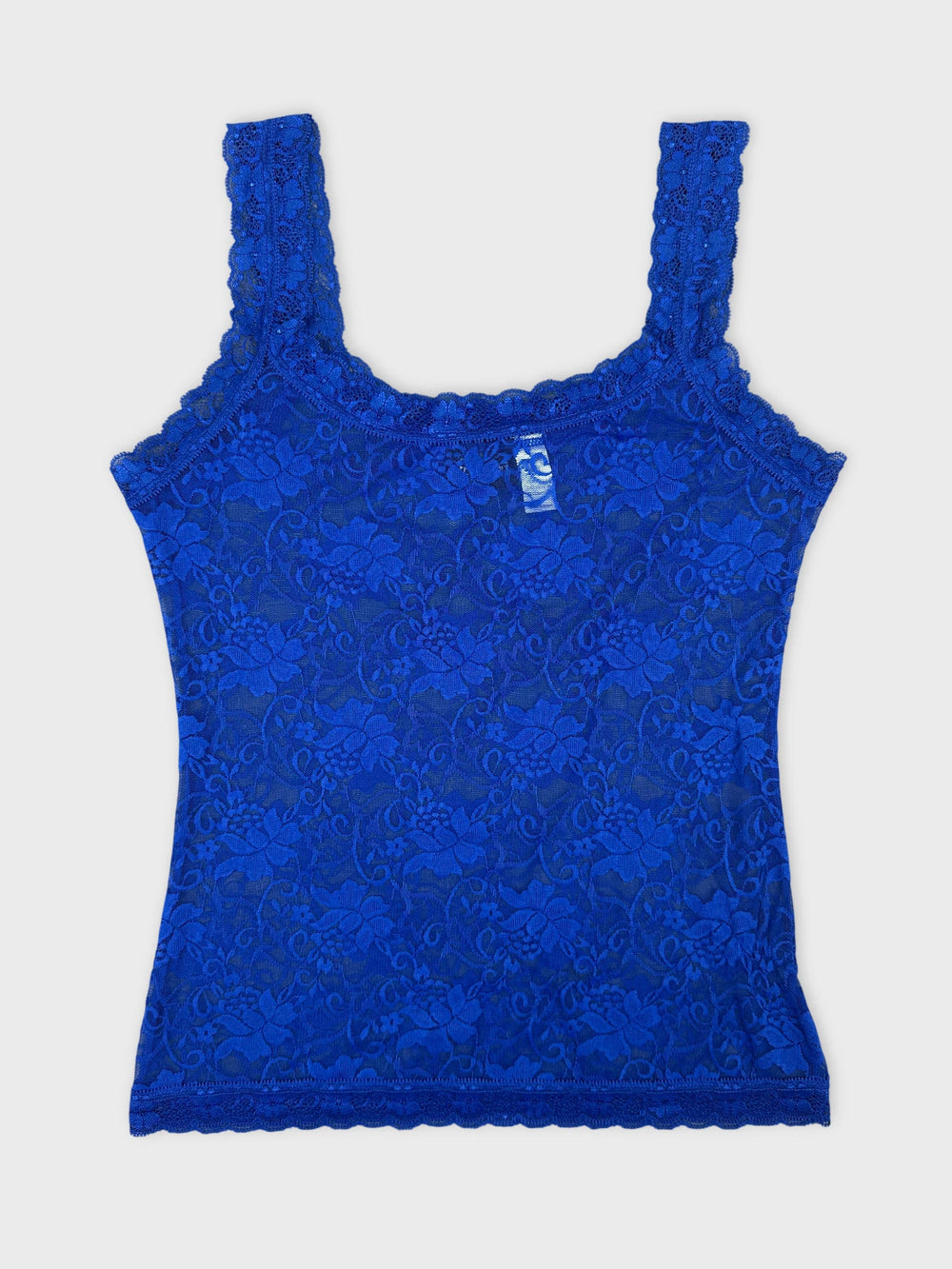 Front view of a blue lace tank top with floral pattern and scalloped trim.