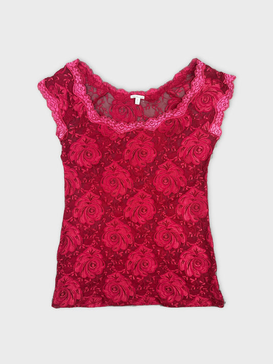 Front view of a red floral lace top with scalloped trim.