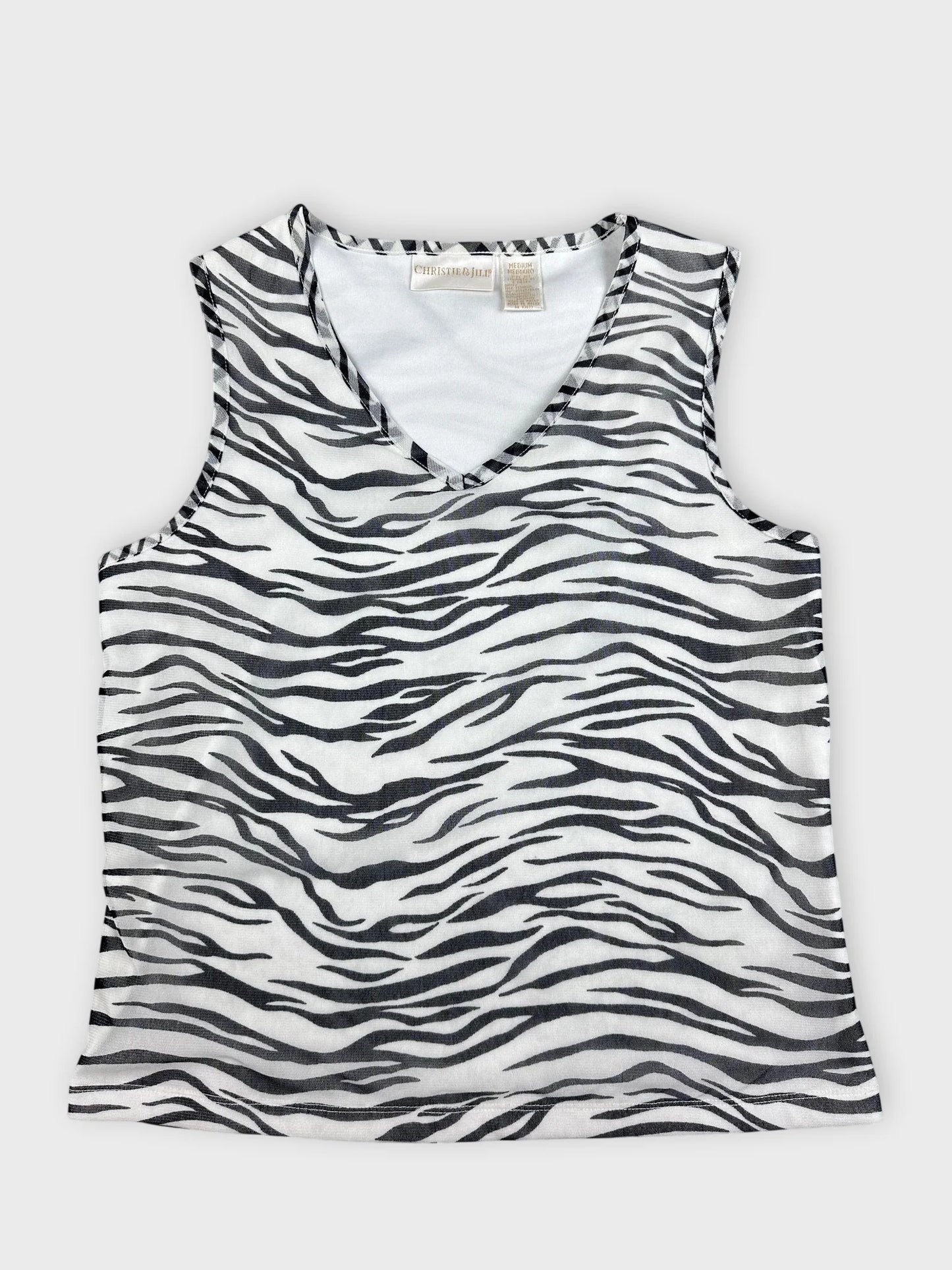 Front view of a sleeveless top in black and white zebra print.