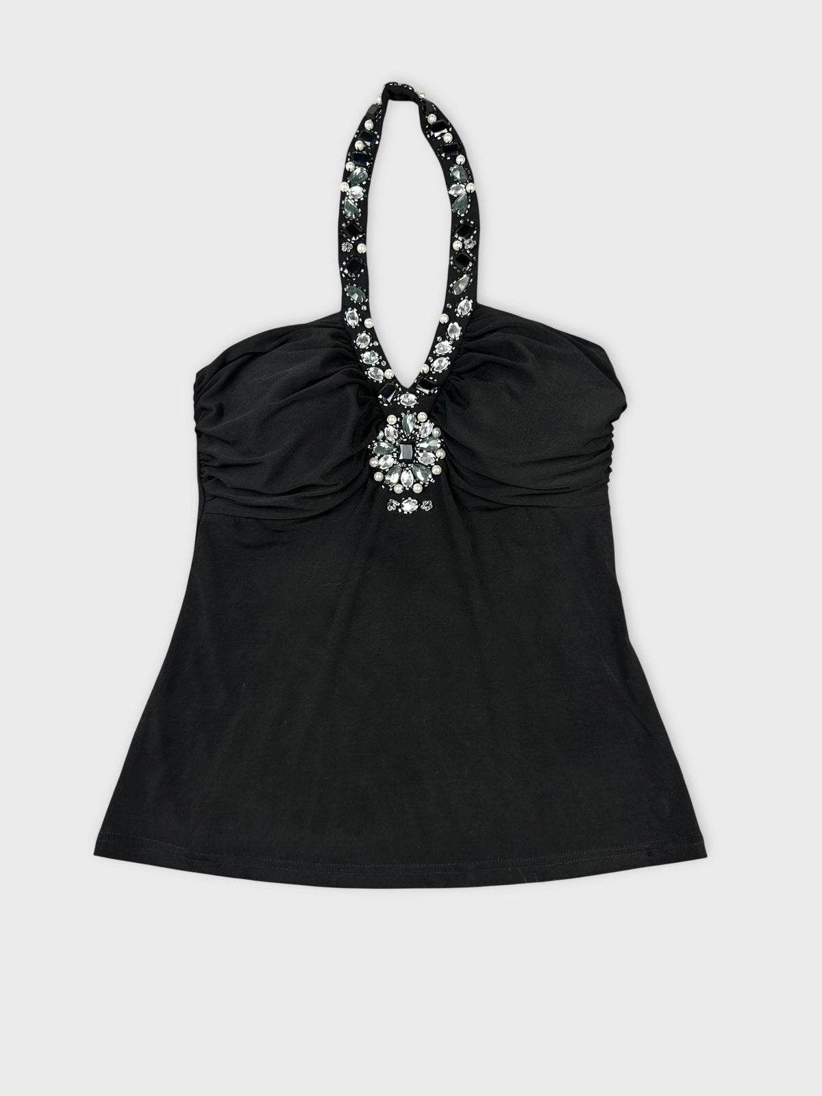 Front view of a black halter top with embellishments at neckline.