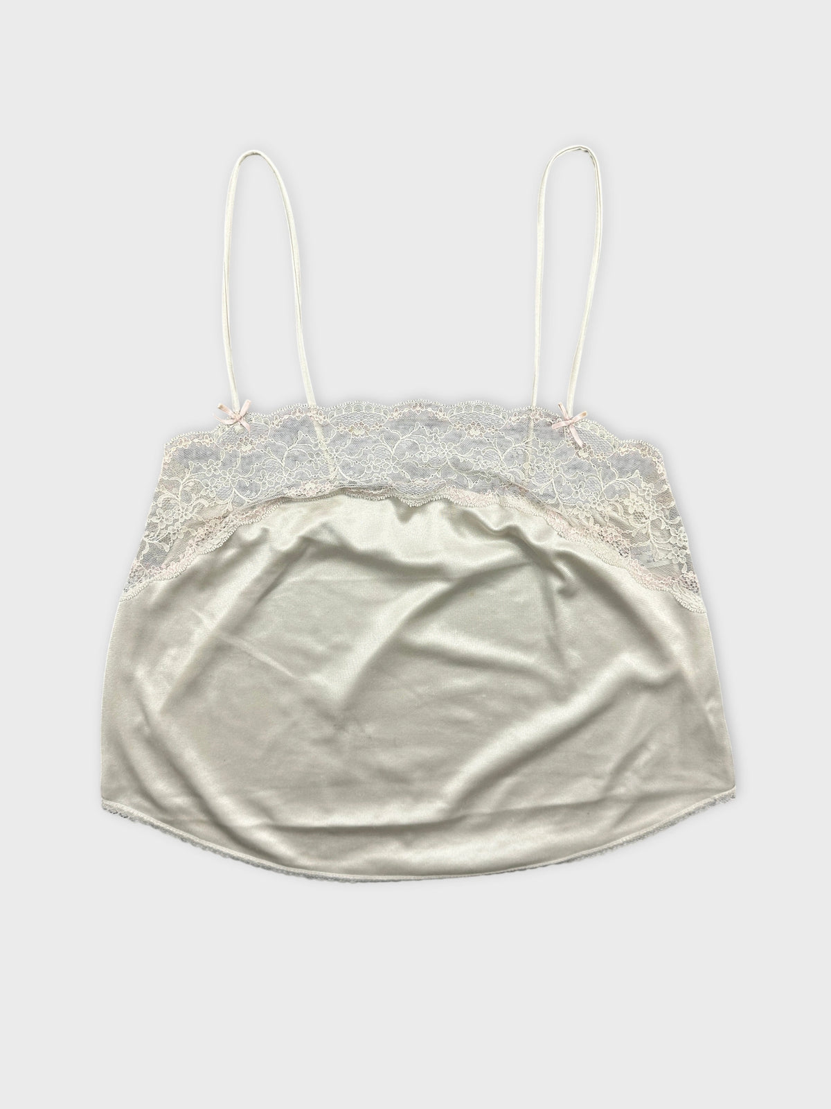 Front view of a vintage women’s cami top in pale gray with lace trim.
