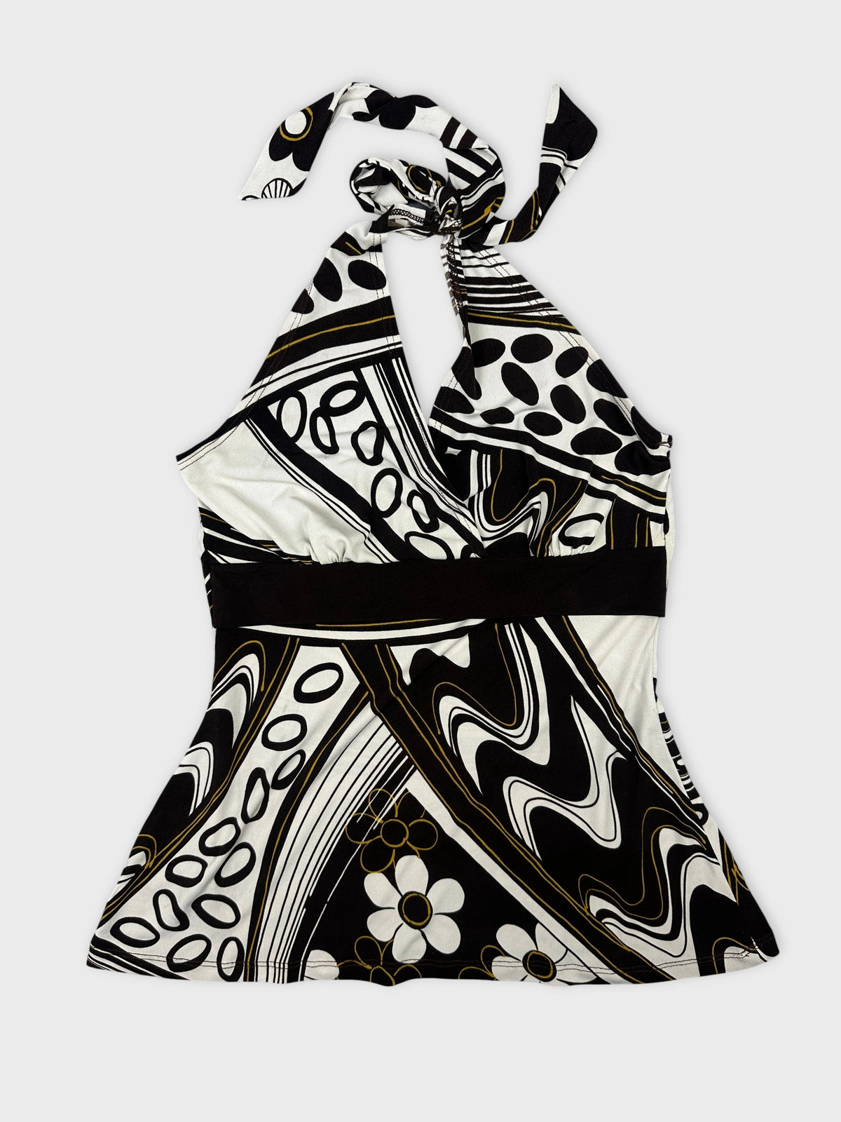 Front view of a halter neck top in black and white with floral patterns.