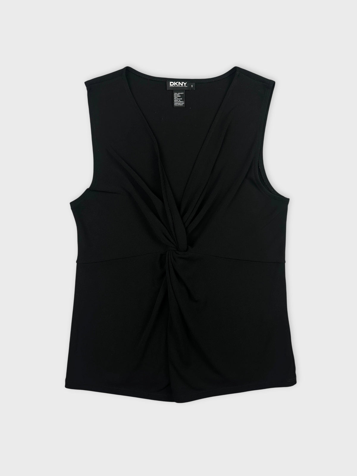 Black sleeveless top with twisted front detail front view.