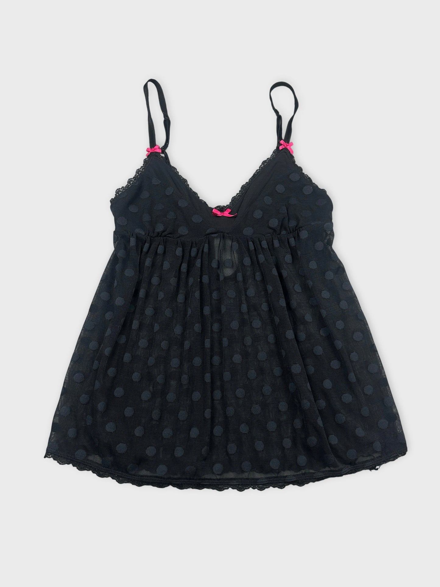 Front view of a black polka dot tank top with pink bows.