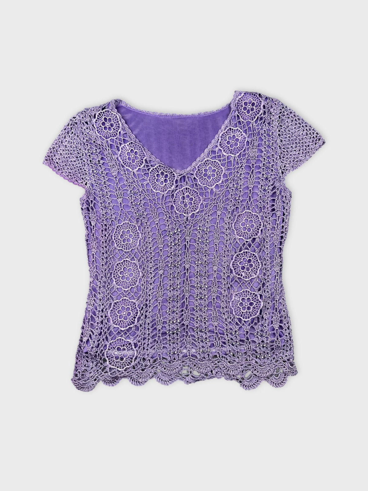 Front view of a purple crochet top with floral pattern.