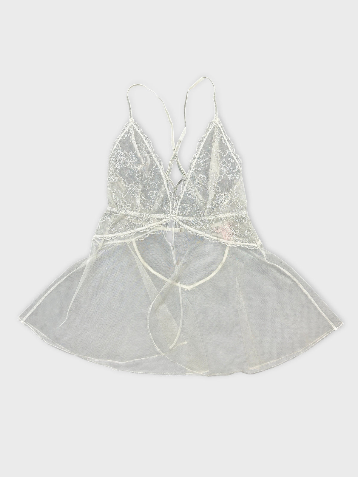 Front view of a vintage sheer lace top in light beige color with delicate trim.