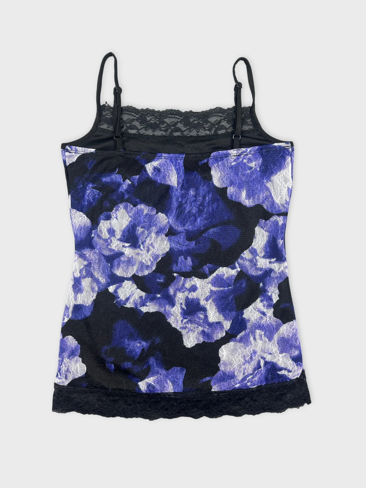 Front view of a sleeveless purple floral camisole with lace trim.