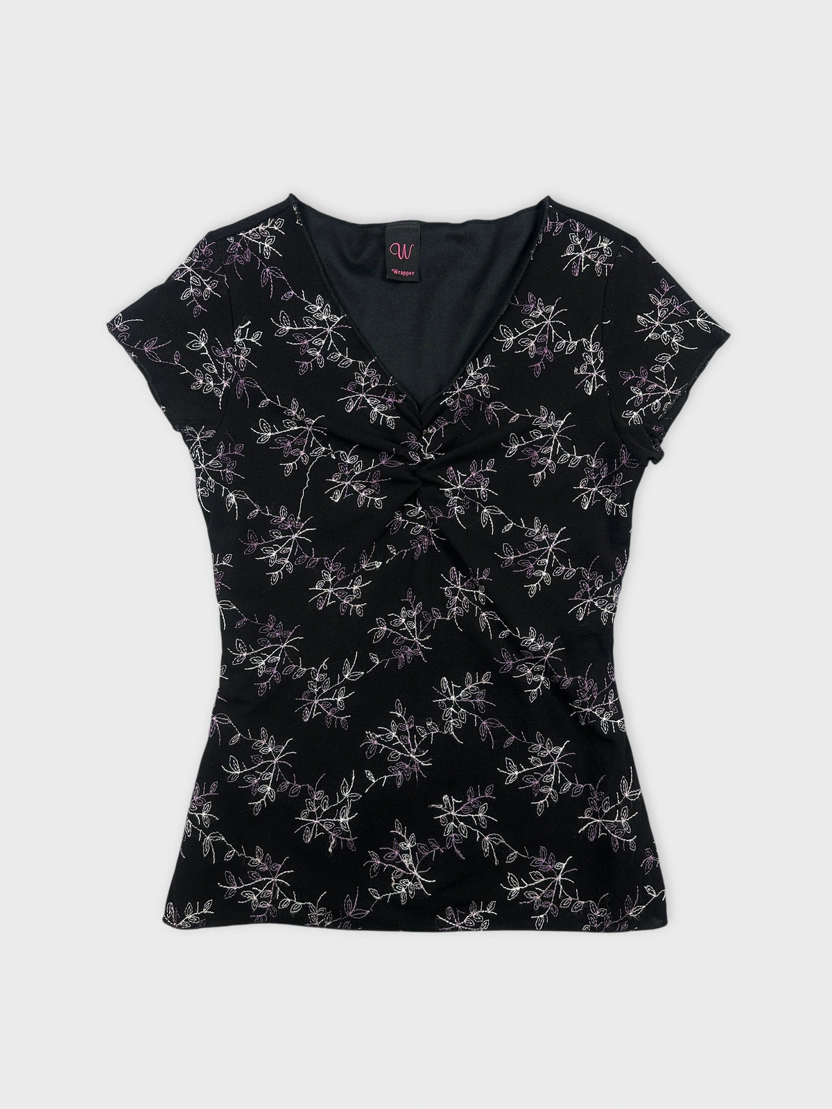 Front view of a black top featuring floral embroidery at the front.
