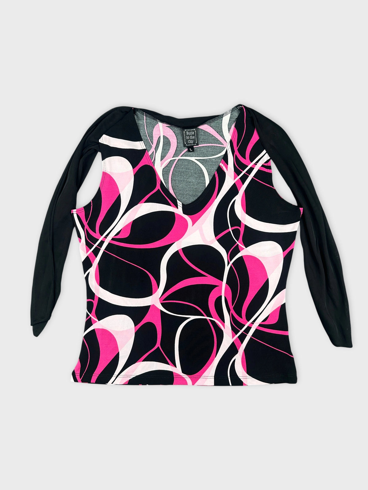 Front view of a long-sleeve top in black with pink abstract patterns.