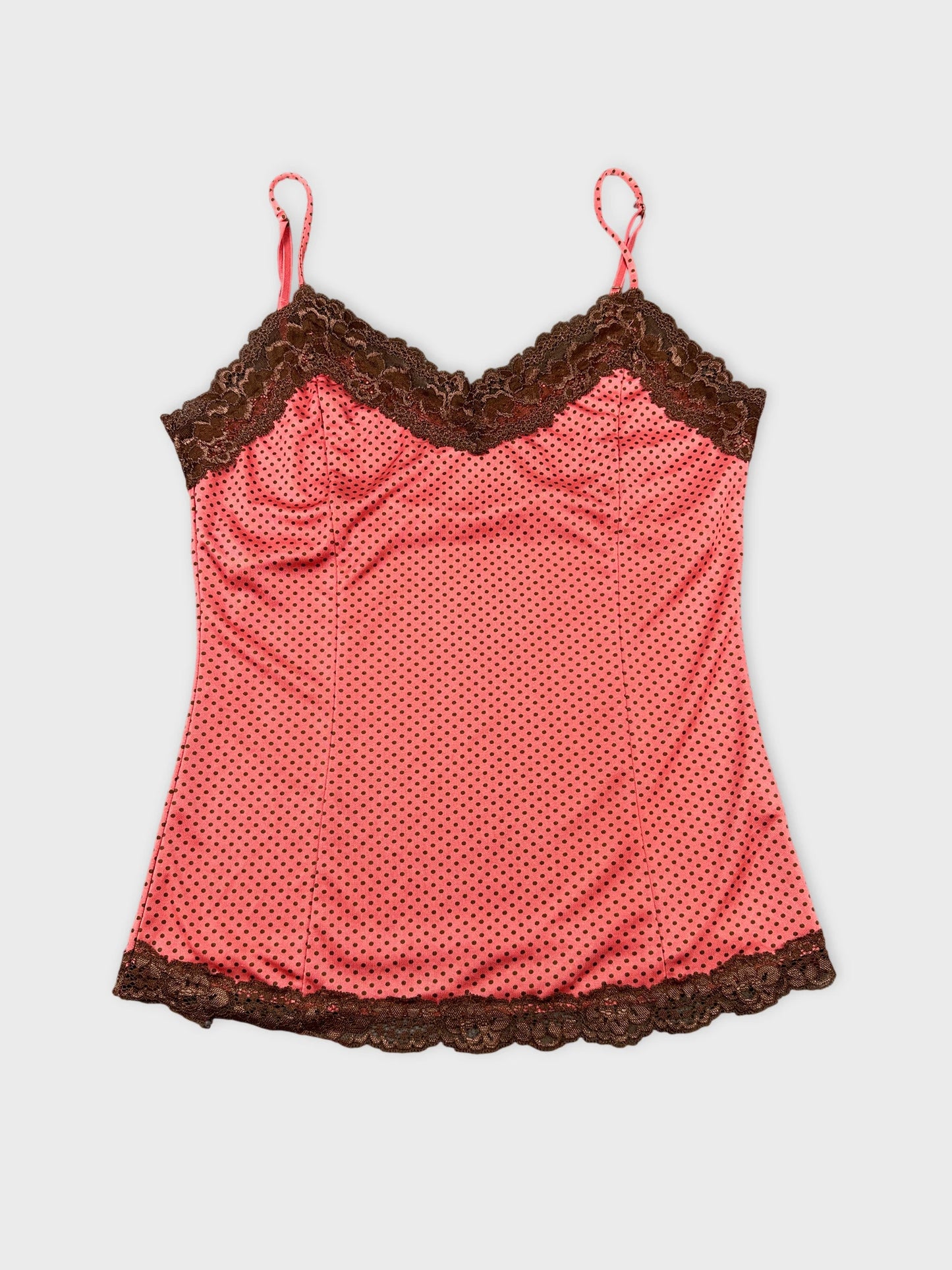 Front view of a pink polka dot top with brown lace trim.