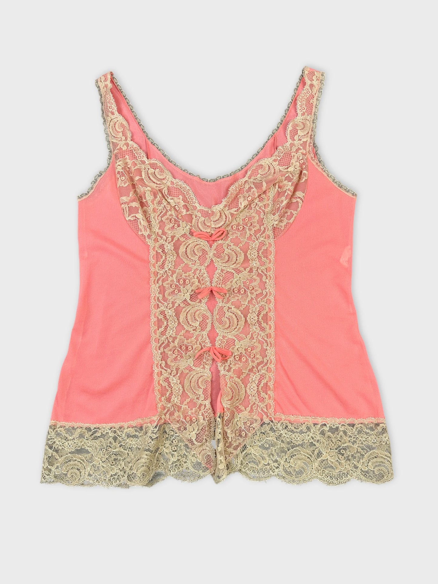 Front view of a pink women's top with lace detailing.