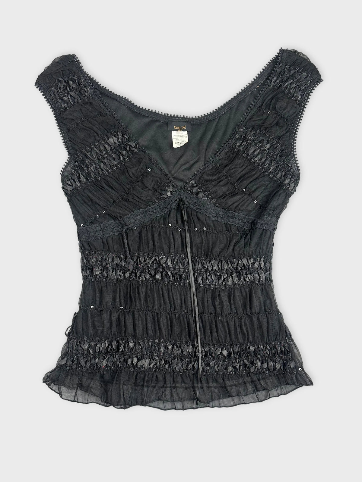Black upper body top with ruffled texture and beaded details front view