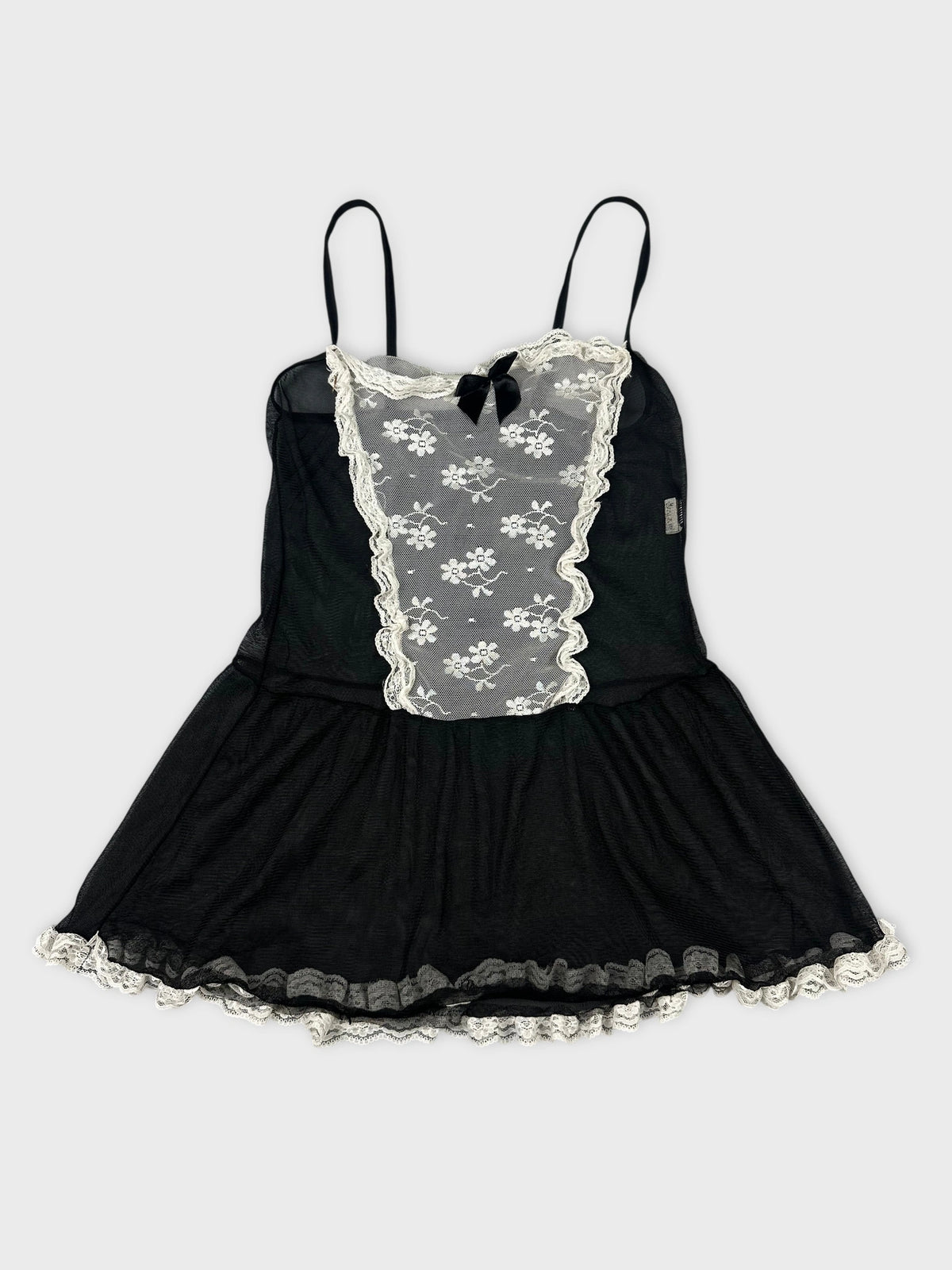 Black vintage top with white lace trim and floral print front view.