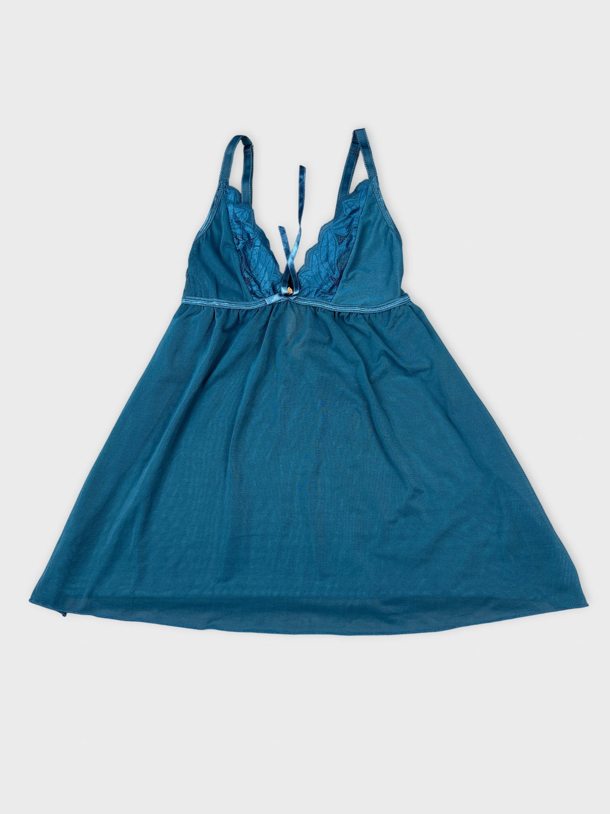 Front view of a vintage teal upper body top featuring lace trim.