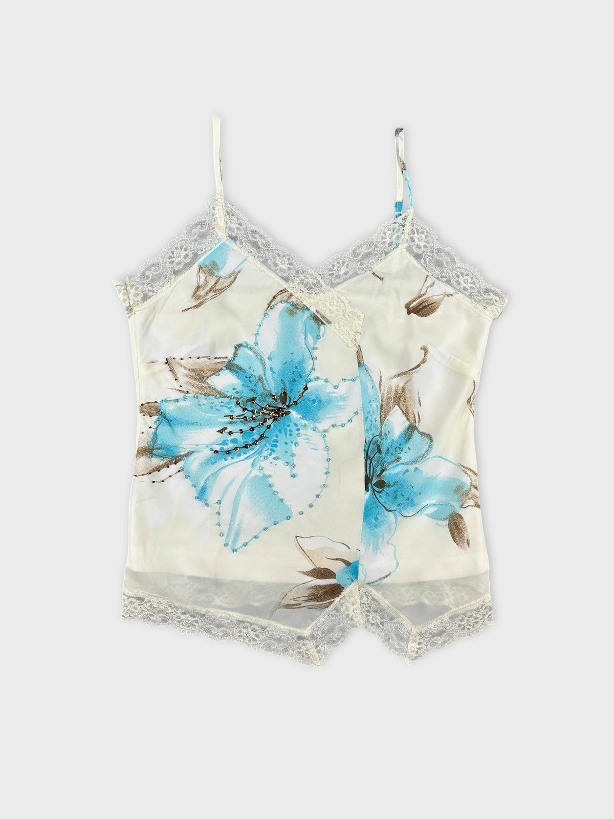Front view of a floral print light blue camisole with lace trim.