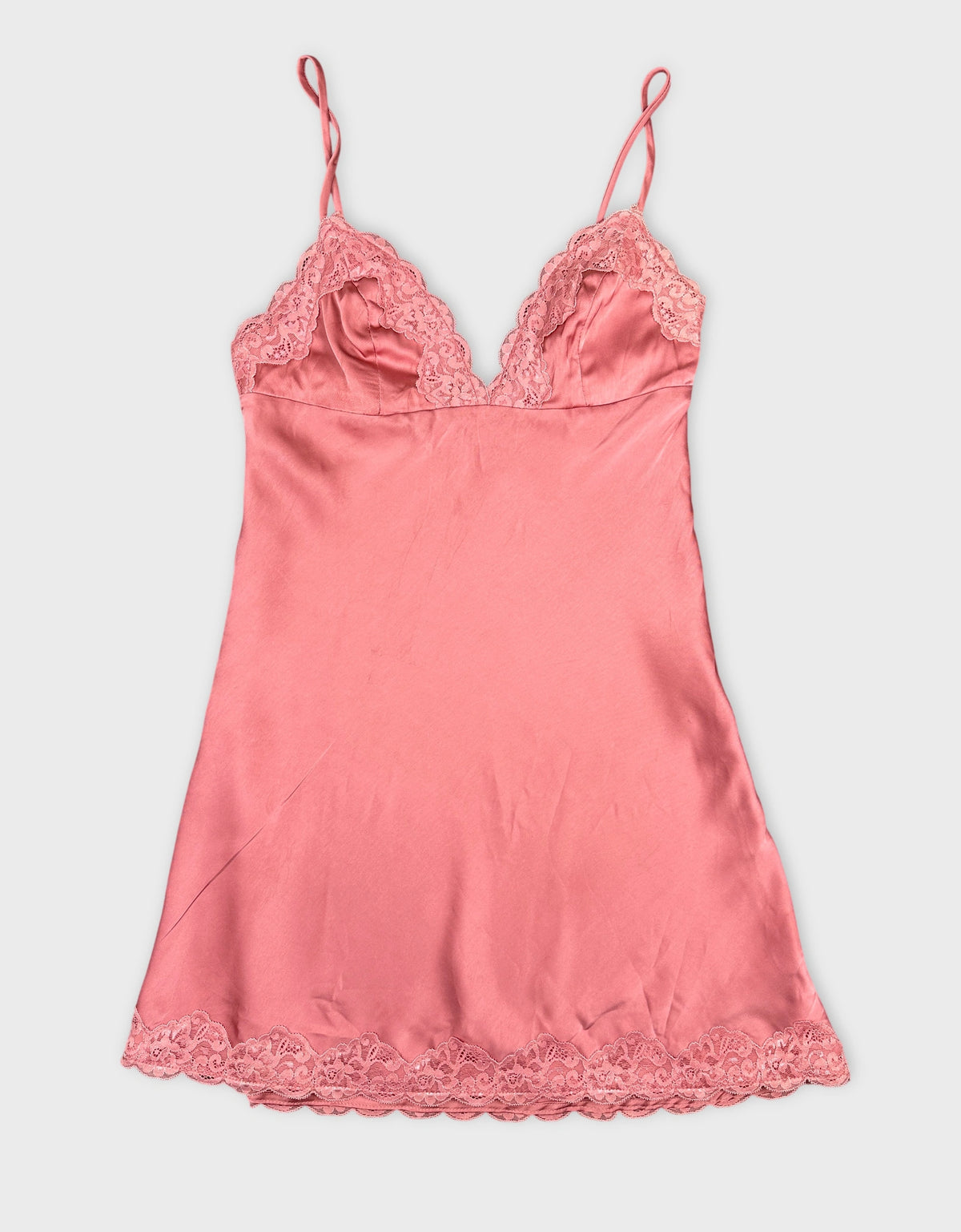 Front view of a pink satin camisole with lace trim.