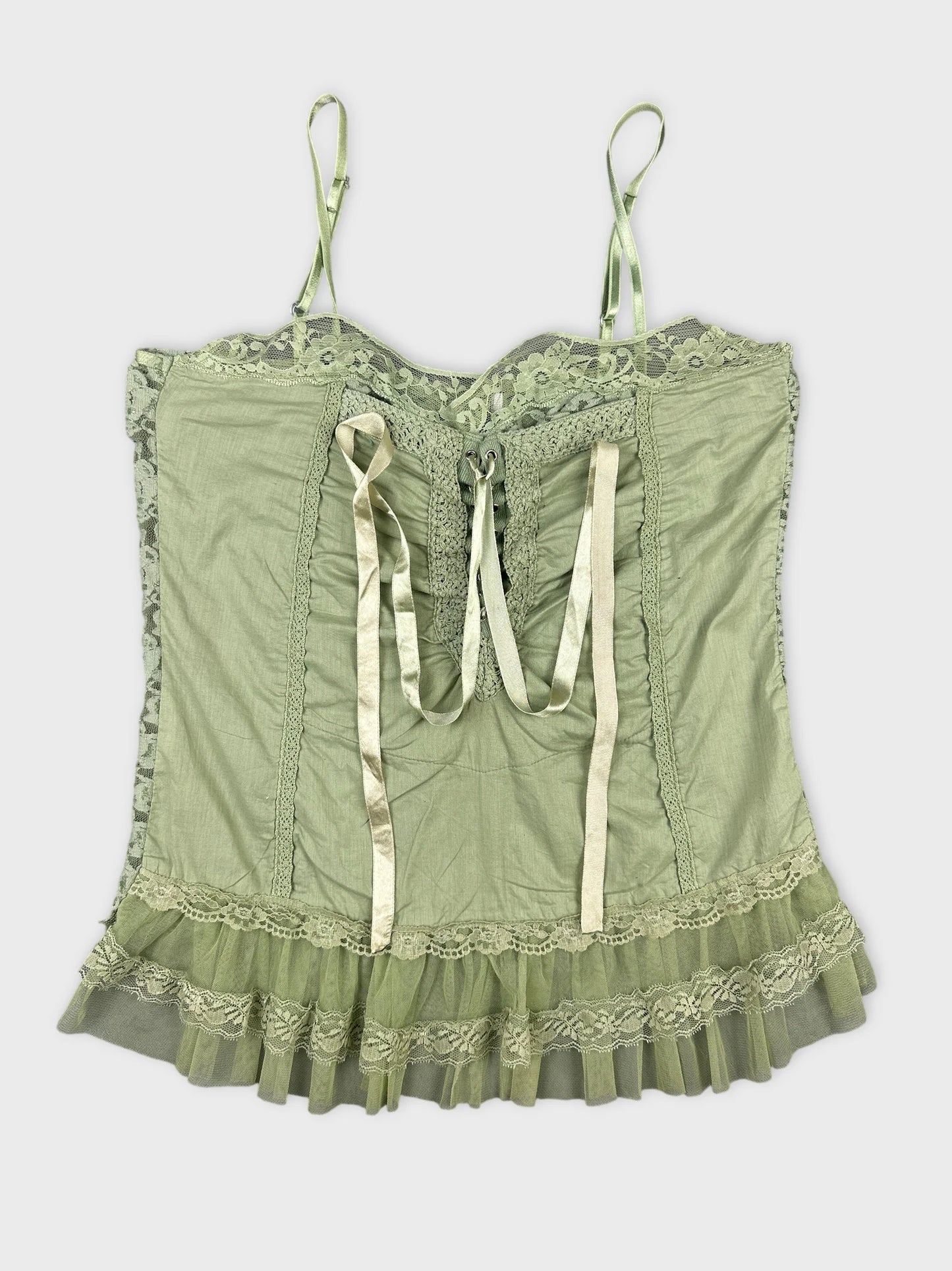 Front view of a vintage green lace top with ruffled hem.