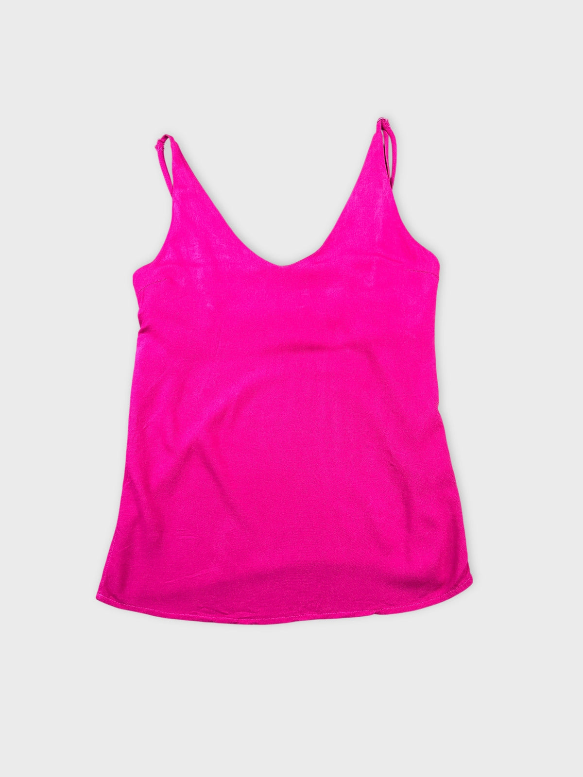 Front view of a pink women's tank top with thin straps.
