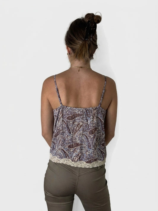 Back view of a patterned blouse with lace trim in shades of brown.