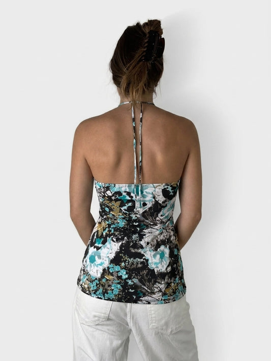 Back view of a floral-patterned black women's top with tie straps.