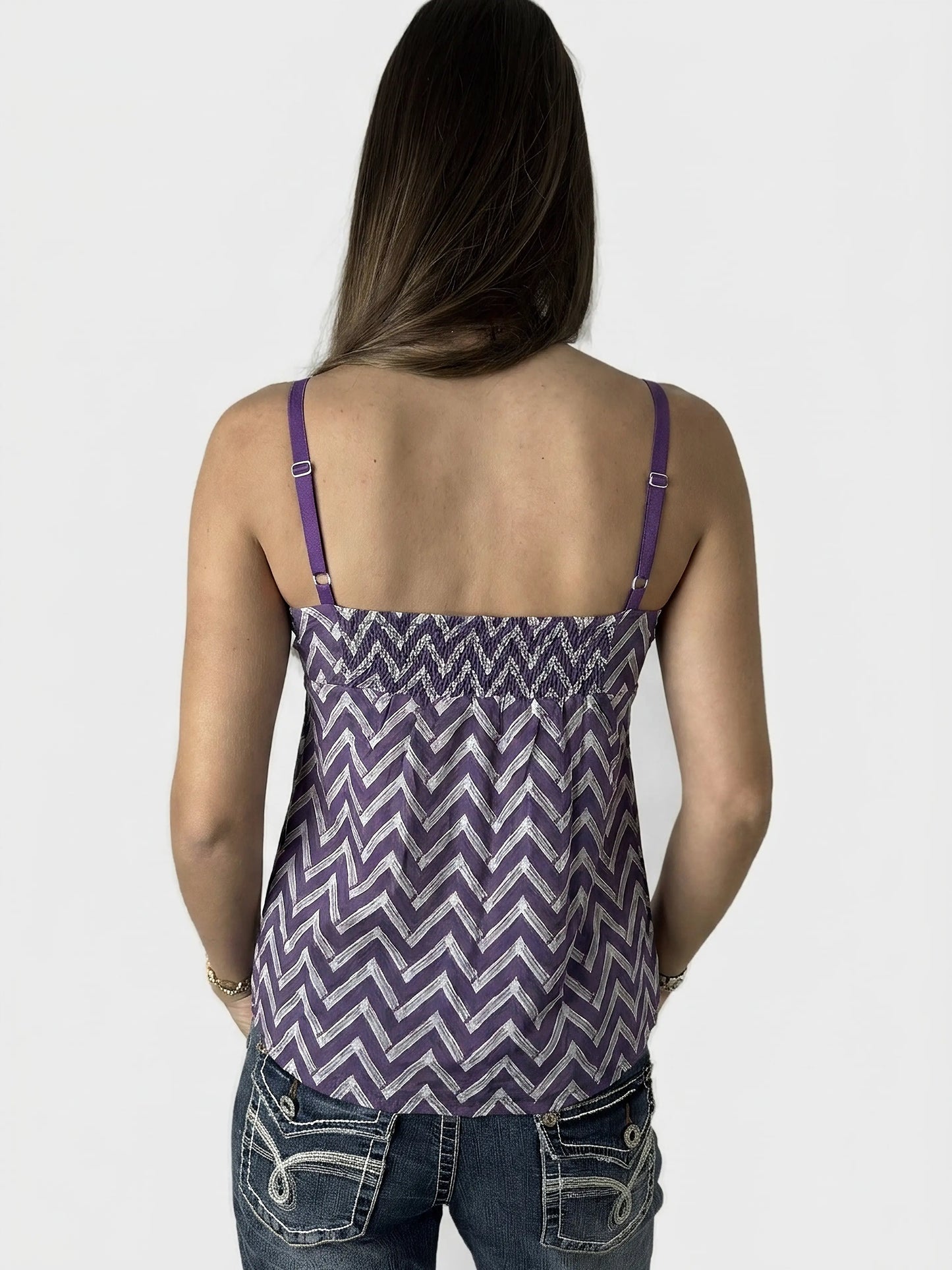 Back view of a women's purple chevron print top with adjustable straps.