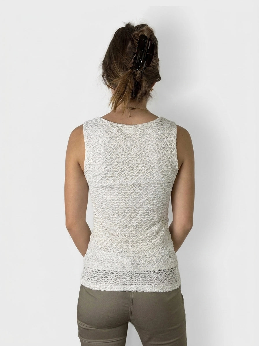 Back view of a white lace tank top with a wavy pattern.