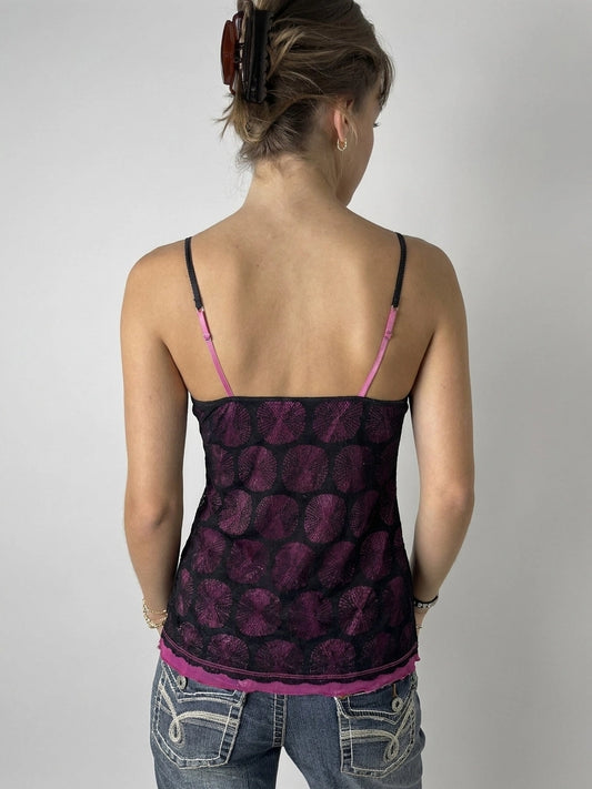 Back view of a black and purple polka dot tank top.