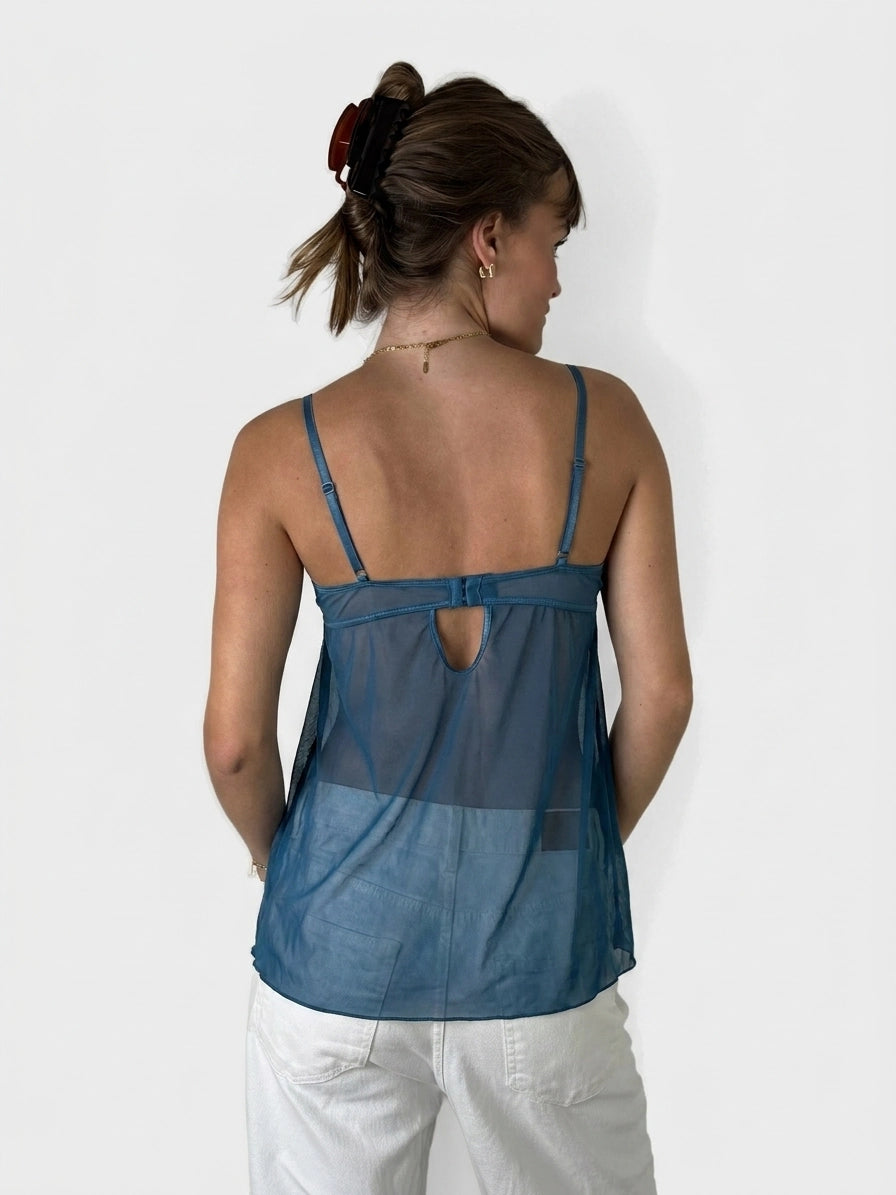 Back view of a sheer teal upper body top featuring a keyhole detail.