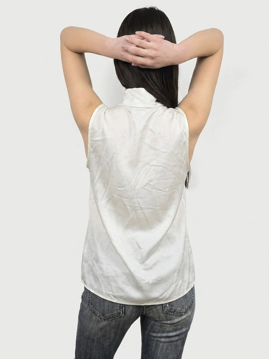 Back view of a white sleeveless top with a smooth texture.