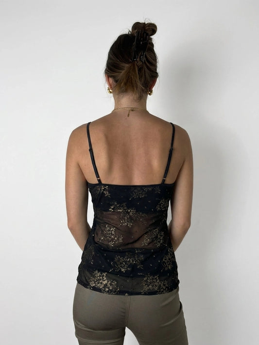 Back view of a black floral print camisole top with thin straps.