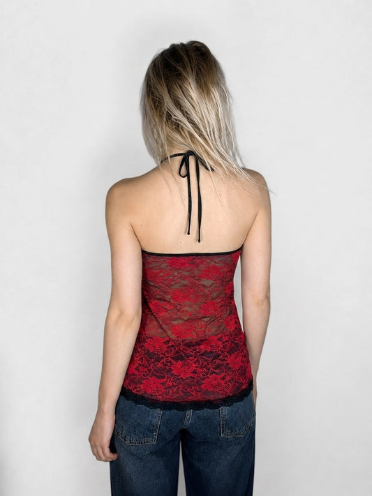 Back view of a red lace upper body top with black trim.