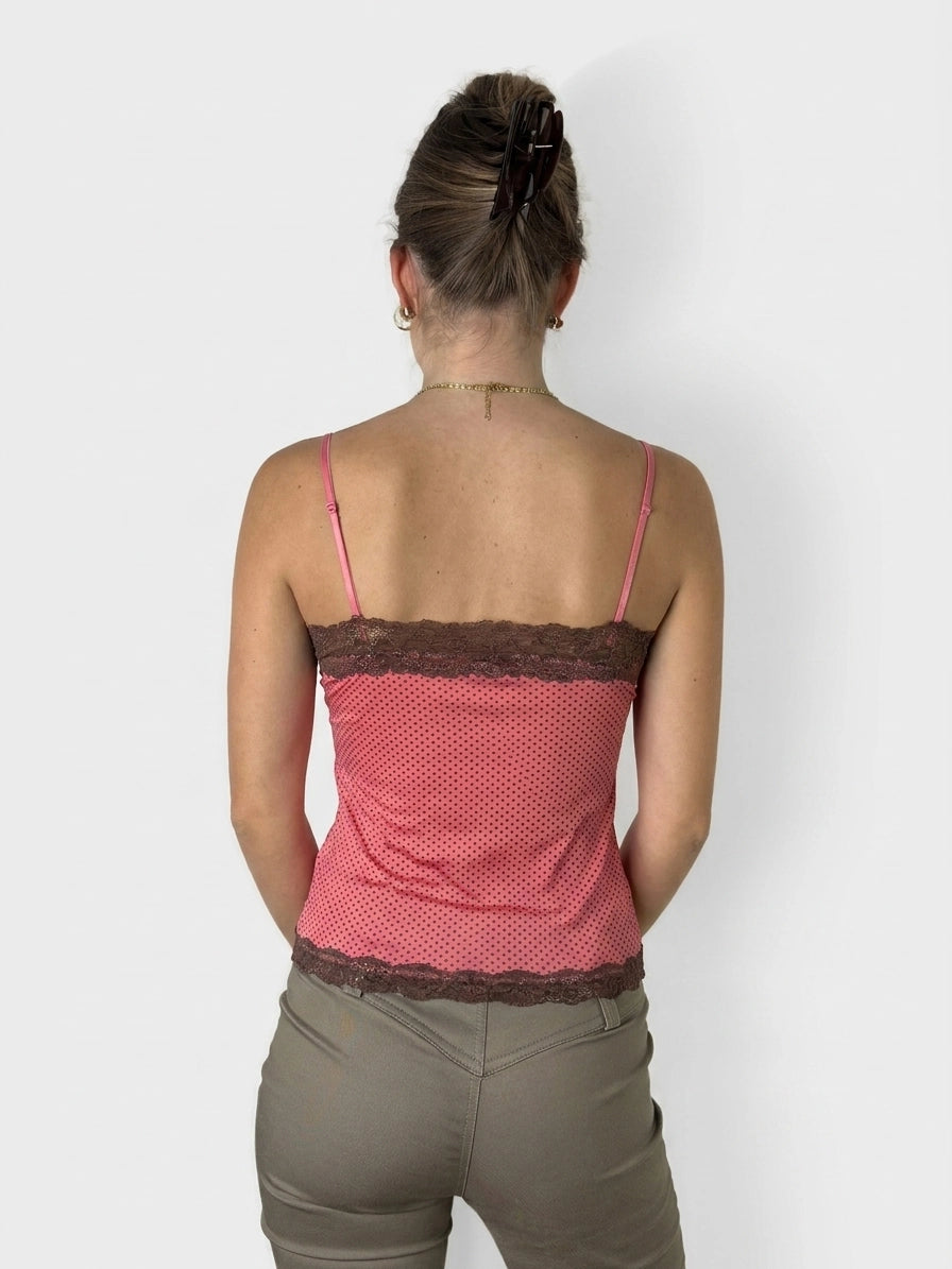 Back view of a pink polka dot camisole with brown lace trim.