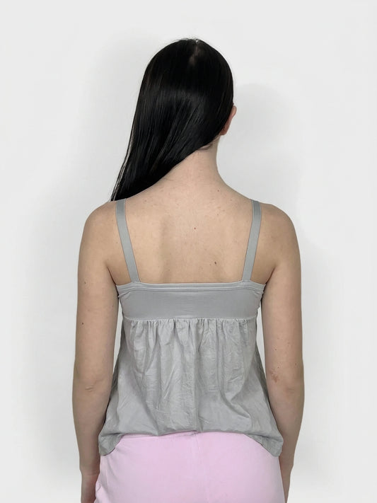 Back view of a grey women's upper body top with gathered detailing.