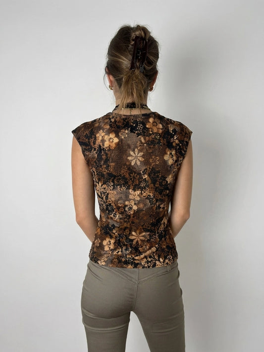Back view of a vintage floral patterned brown top with cap sleeves.