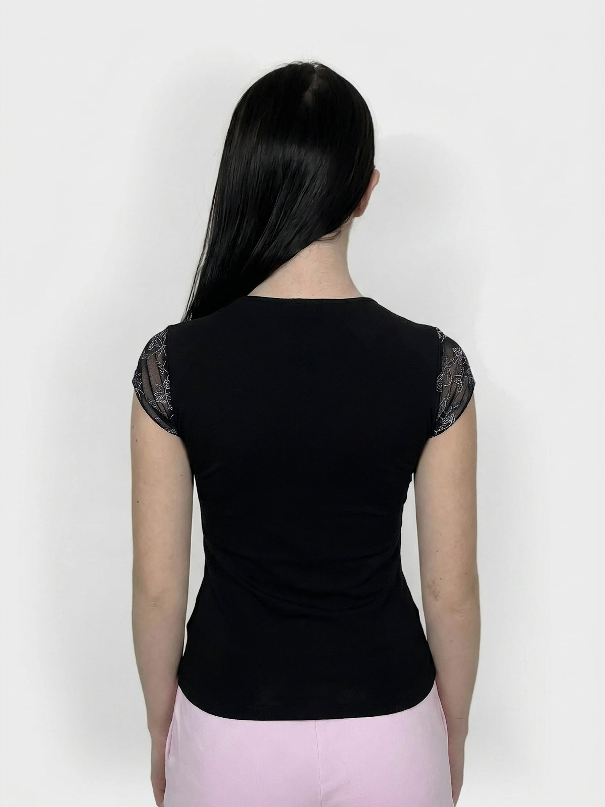Black upper body top with lace trim, seen from the back view.