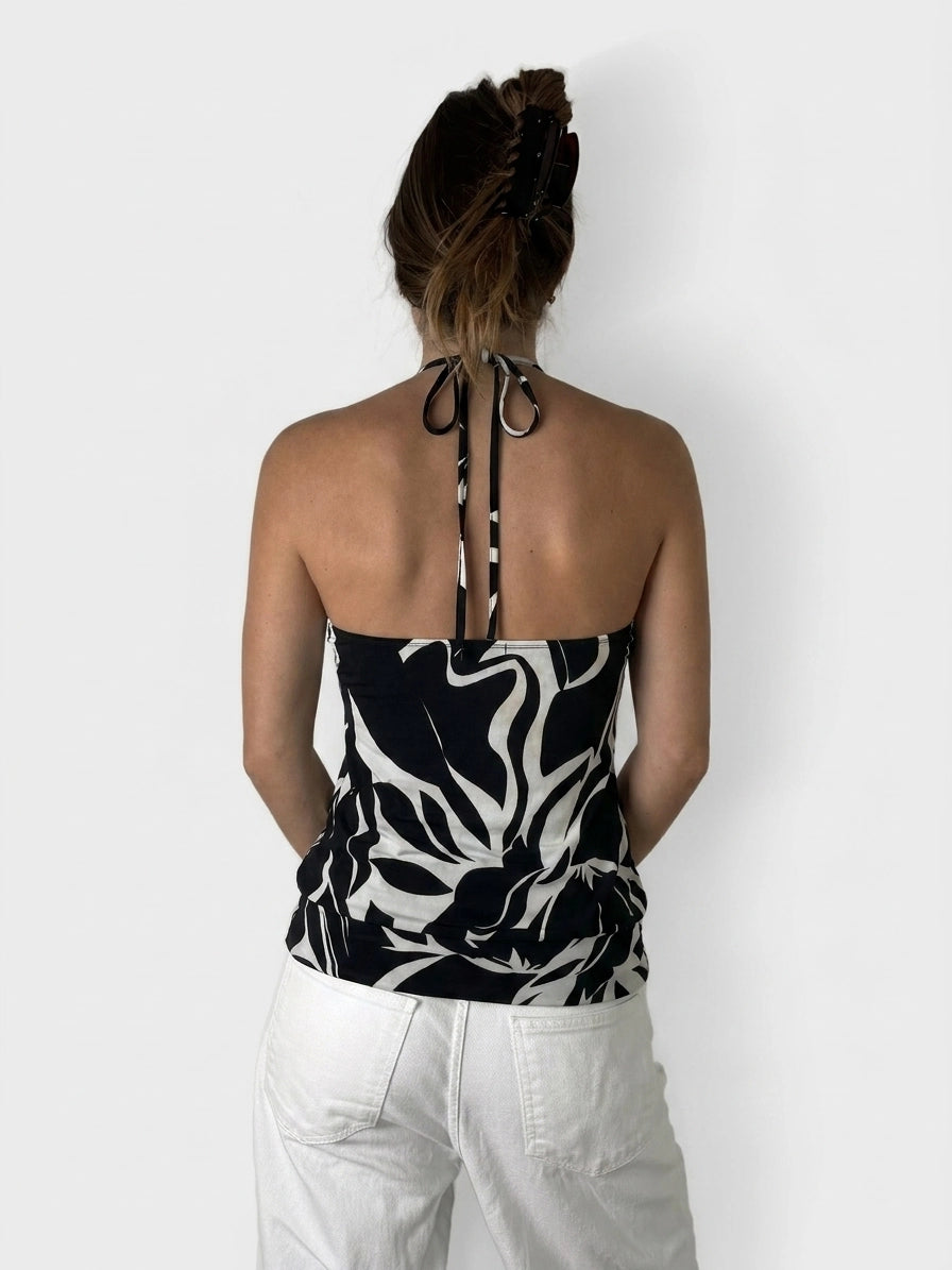 Back view of a black and white floral top with tie straps.