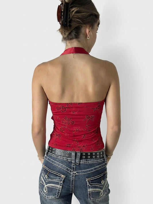 Back view of a red floral print halter neck top.