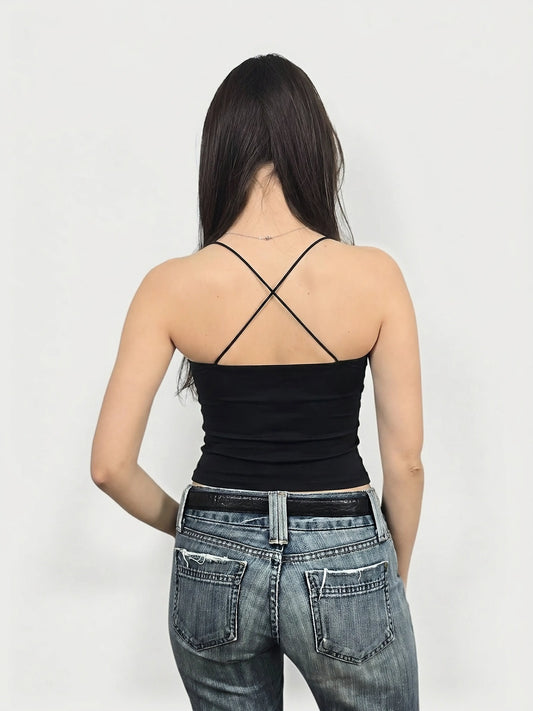 Black upper body top with crisscross back straps, back view.