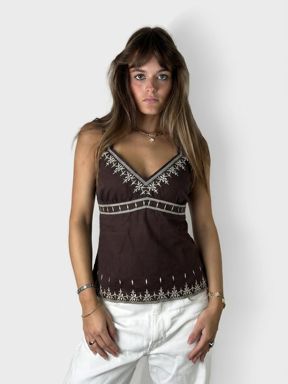 Brown upper body top featuring intricate embroidery, displayed in front view.