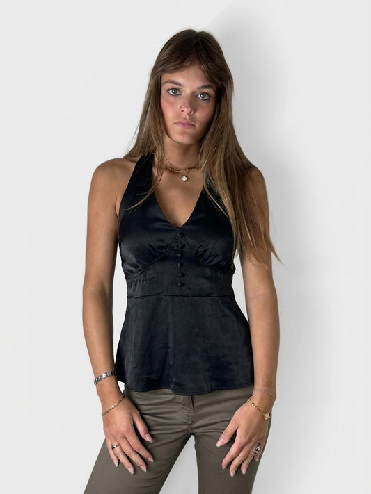 Front view of a black halter top with button detail.